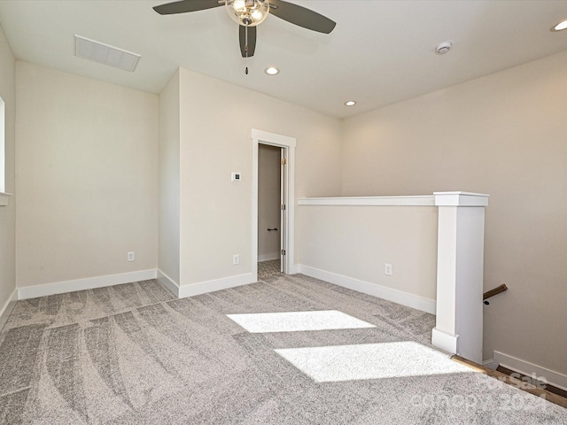 carpeted spare room with ceiling fan