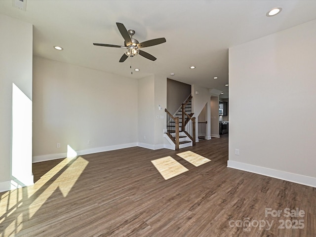 unfurnished living room with a ceiling fan, wood finished floors, stairs, baseboards, and recessed lighting