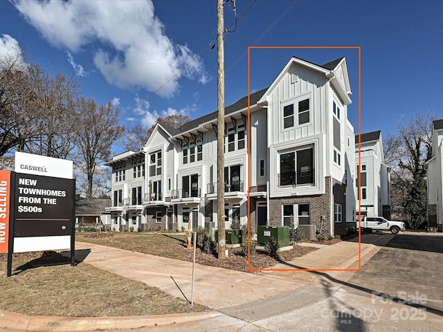 view of front of house with board and batten siding and brick siding