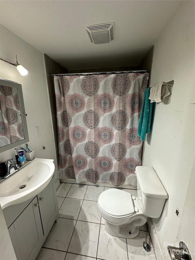 bathroom featuring toilet, vanity, and walk in shower