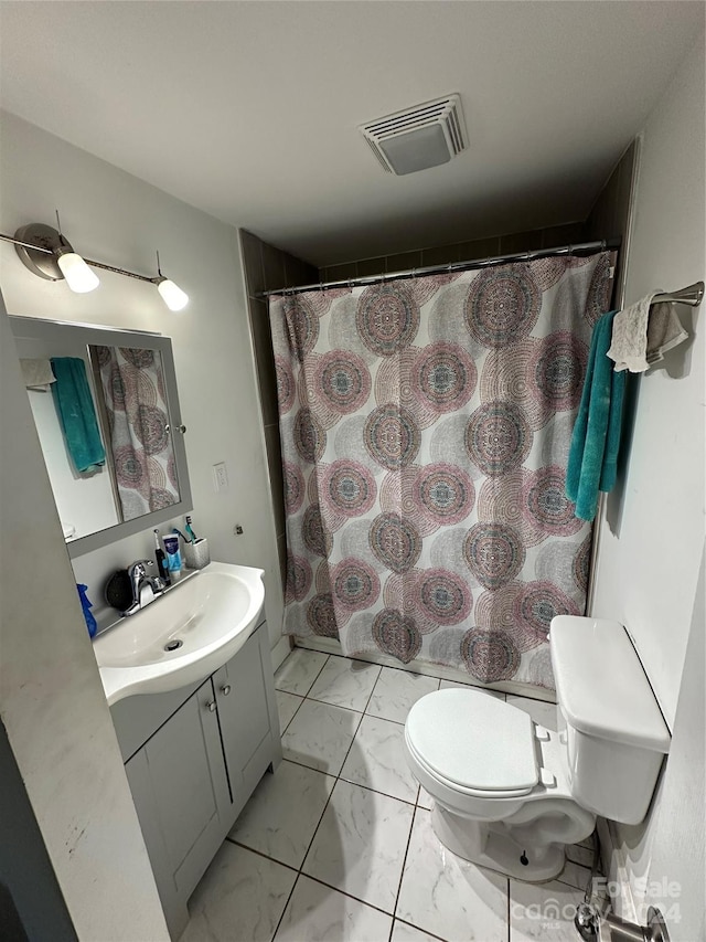 bathroom featuring toilet, walk in shower, and vanity