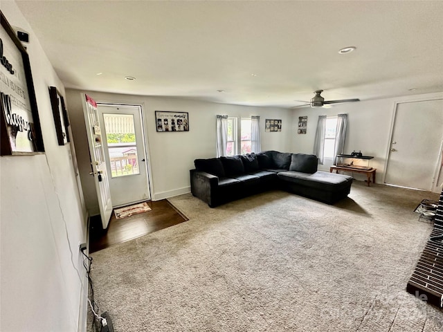 carpeted living room featuring ceiling fan