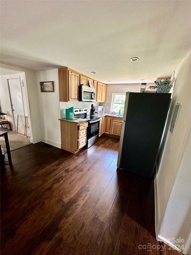 kitchen with decorative backsplash, dark wood-type flooring, appliances with stainless steel finishes, light brown cabinets, and light stone counters