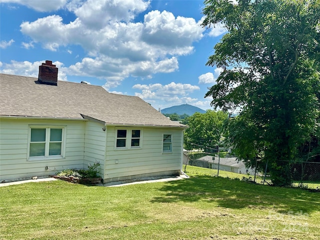 exterior space with a mountain view and a yard