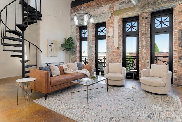 living room with brick wall, a high ceiling, and concrete flooring