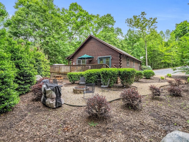 view of yard with a deck and a fire pit