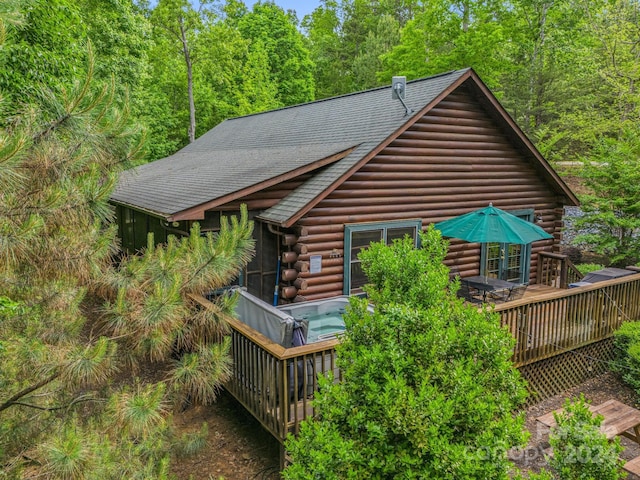 view of property exterior featuring a wooden deck