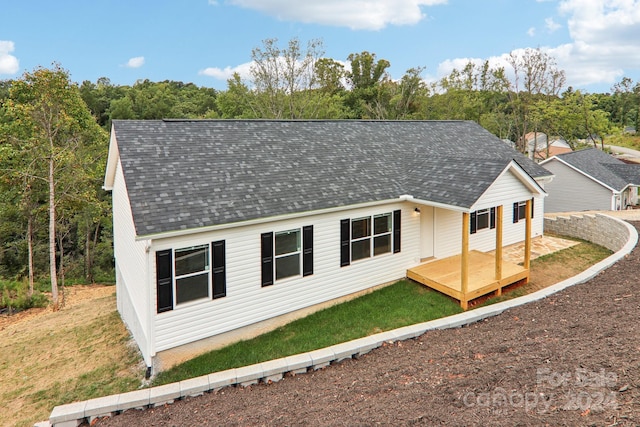 view of front of house featuring a front yard and a deck