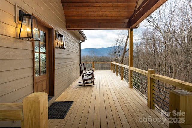 wooden deck with a mountain view