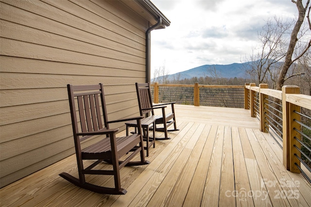 wooden deck with a mountain view