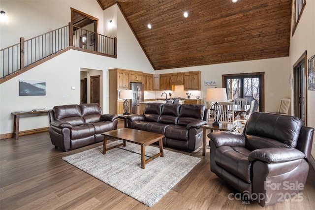 living room featuring sink, dark hardwood / wood-style floors, high vaulted ceiling, and wooden ceiling