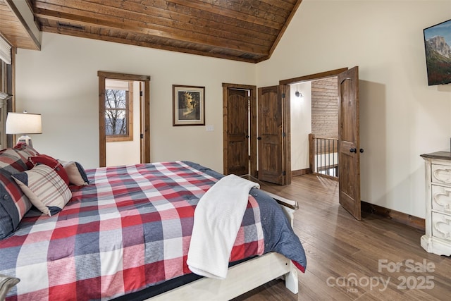 bedroom with wood ceiling, lofted ceiling, and hardwood / wood-style flooring