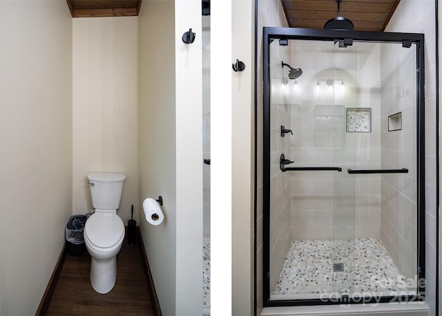 bathroom featuring hardwood / wood-style flooring, walk in shower, and toilet