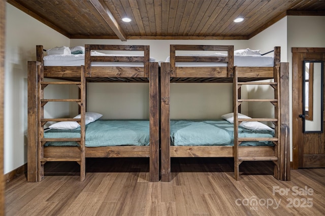 unfurnished bedroom with wood-type flooring and wooden ceiling