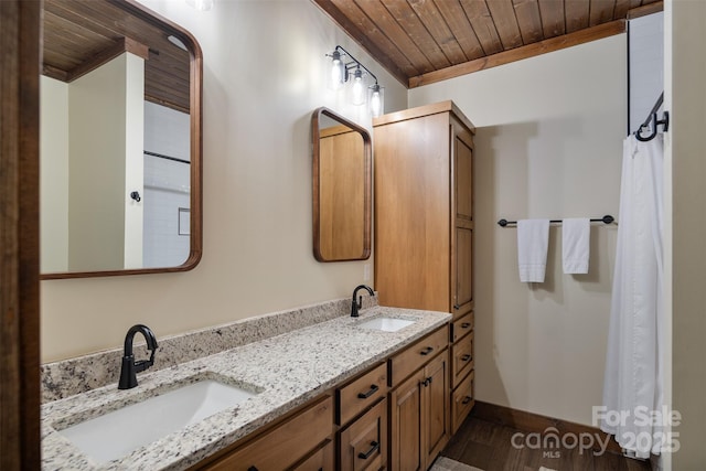 bathroom featuring vanity, wood-type flooring, and wooden ceiling