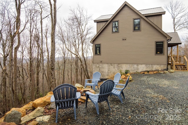 view of property exterior featuring an outdoor fire pit