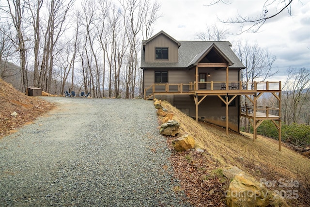 rear view of house featuring a deck