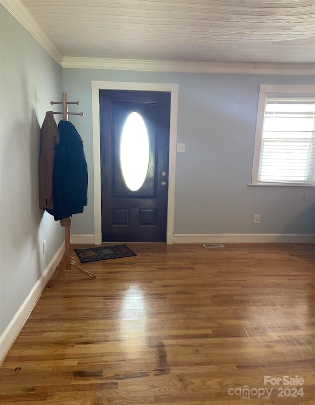 entryway featuring wood-type flooring and crown molding