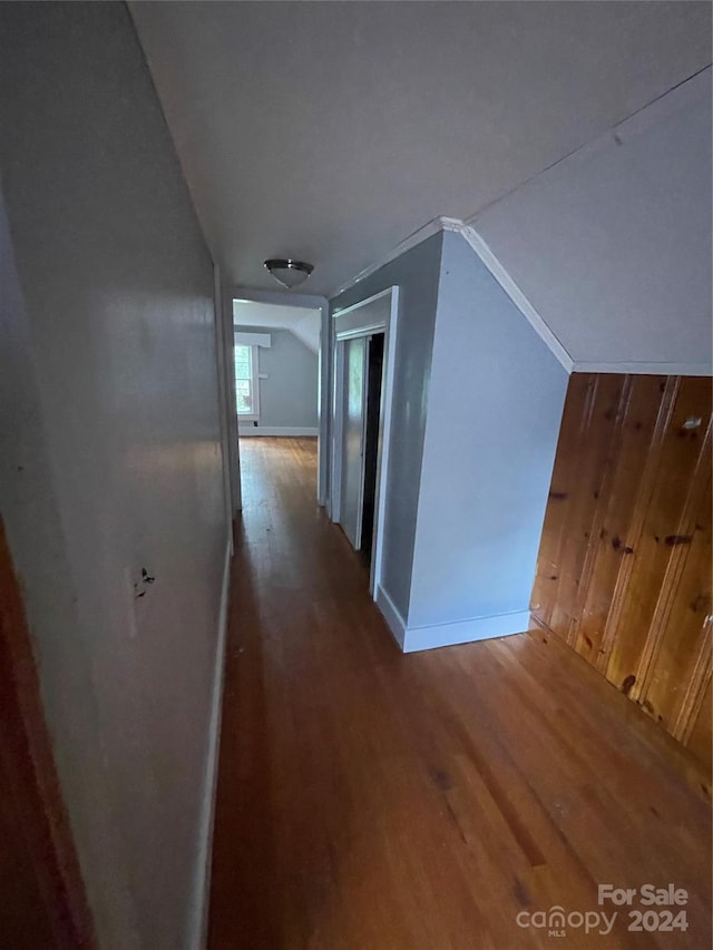 corridor featuring lofted ceiling and wood-type flooring