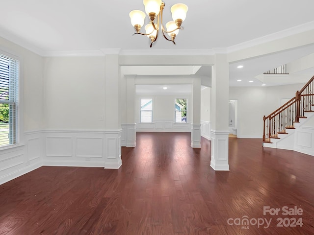 foyer featuring a notable chandelier, dark hardwood / wood-style flooring, crown molding, and plenty of natural light