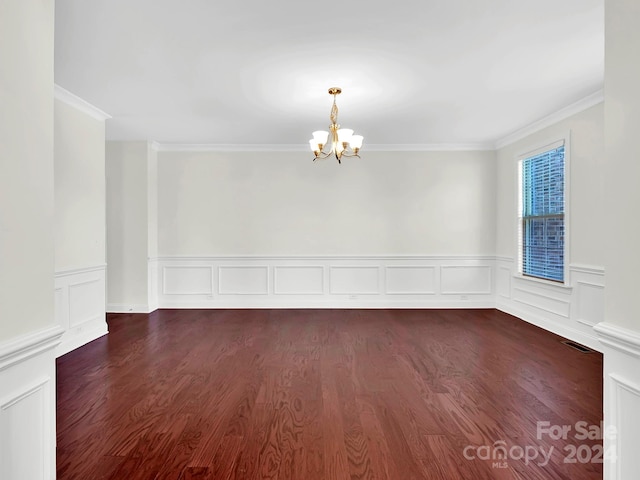 unfurnished room with a notable chandelier, ornamental molding, and dark wood-type flooring