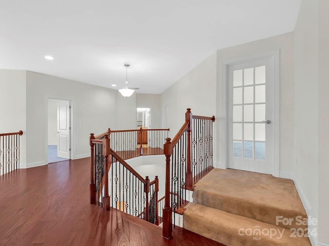 stairway with dark hardwood / wood-style floors