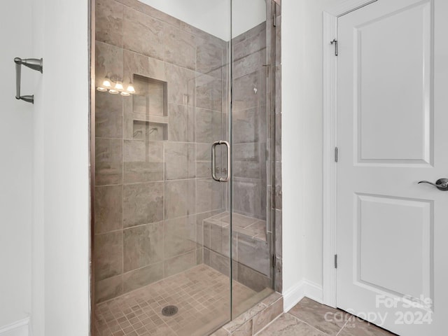 bathroom with tile floors and an enclosed shower