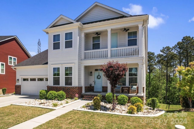 view of front of property with a garage, ceiling fan, a front lawn, and a balcony