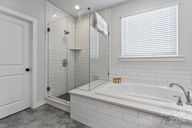 bathroom featuring separate shower and tub and tile floors