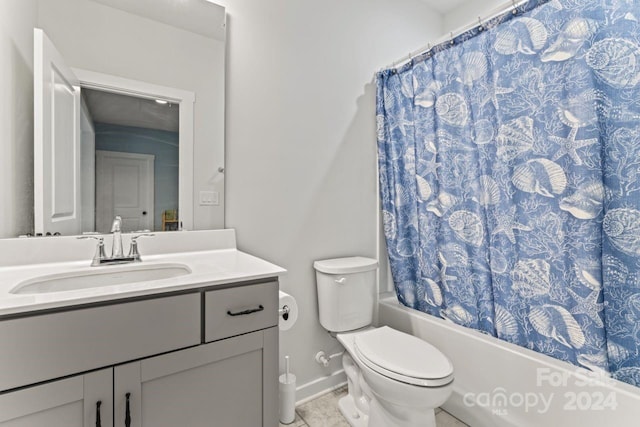 full bathroom featuring tile flooring, shower / tub combo with curtain, toilet, and vanity