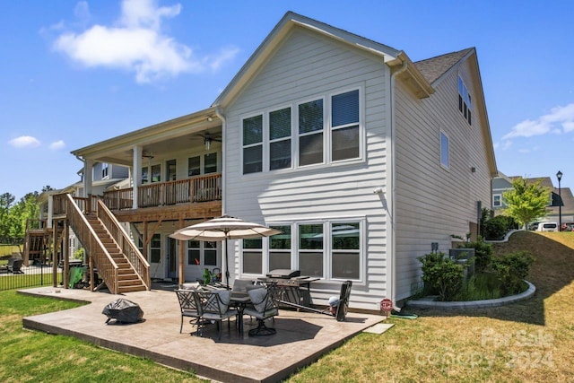 back of property with a yard and a patio area