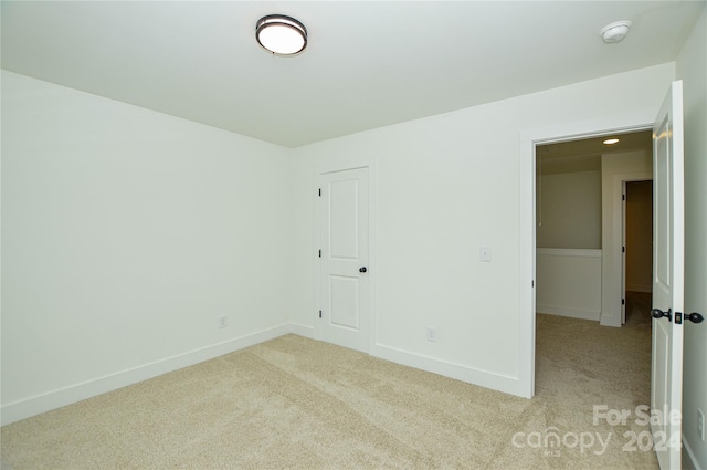 unfurnished room with light colored carpet