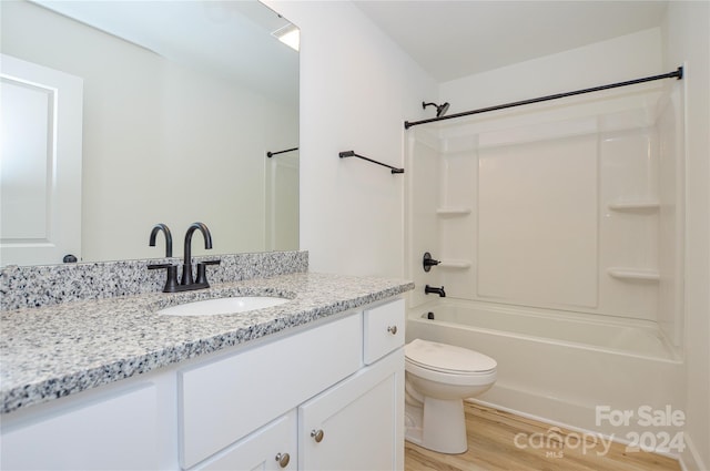 full bathroom with toilet, hardwood / wood-style floors, tub / shower combination, and vanity