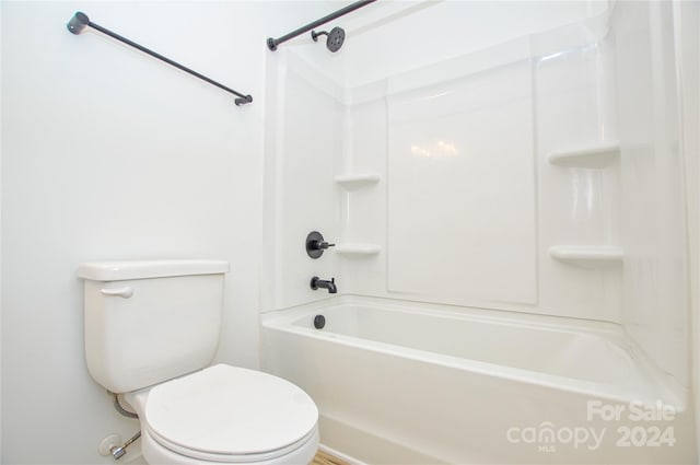 bathroom featuring tub / shower combination and toilet