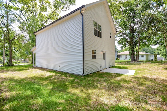 rear view of house featuring a patio and a lawn