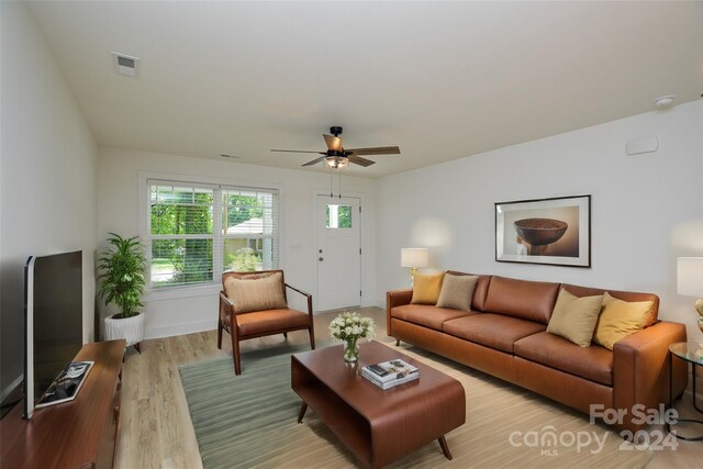 living room featuring ceiling fan and light hardwood / wood-style floors