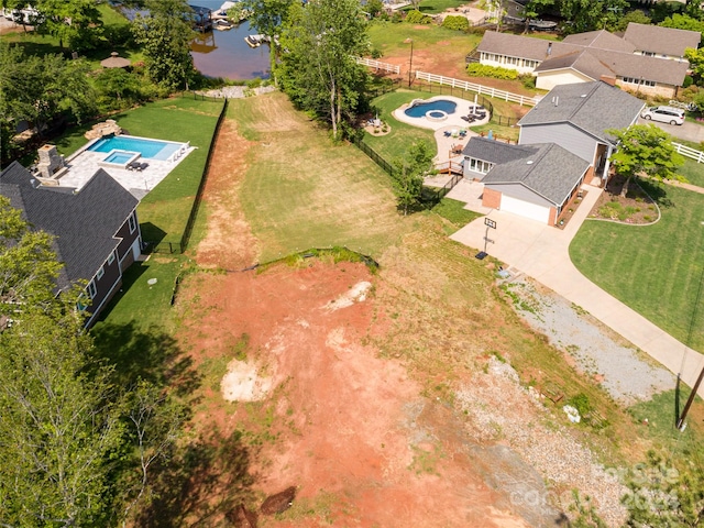 birds eye view of property with a water view