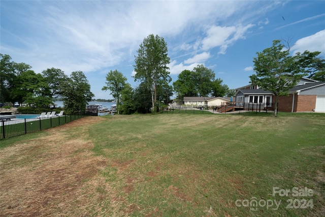 view of yard with a deck with water view