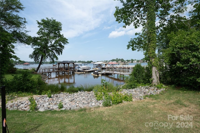 dock area featuring a water view and a yard