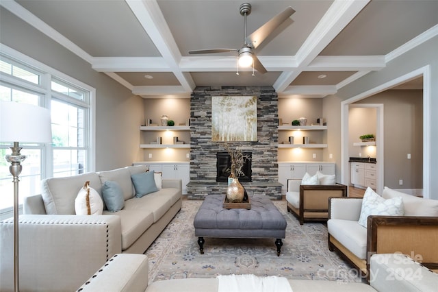 living room featuring beam ceiling, built in features, and coffered ceiling