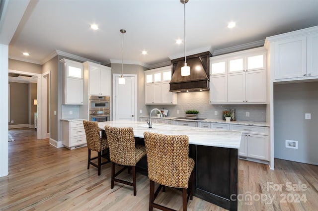 kitchen featuring pendant lighting and white cabinetry