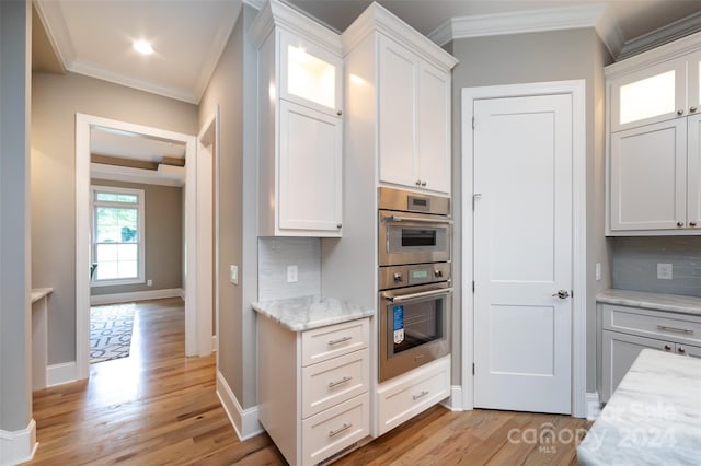 kitchen featuring backsplash and white cabinets