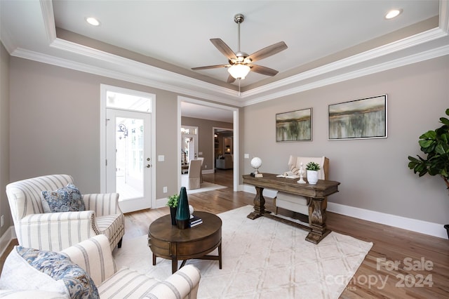 interior space with ceiling fan, crown molding, light hardwood / wood-style flooring, and a raised ceiling