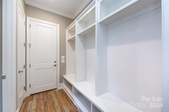 mudroom with crown molding and light hardwood / wood-style floors