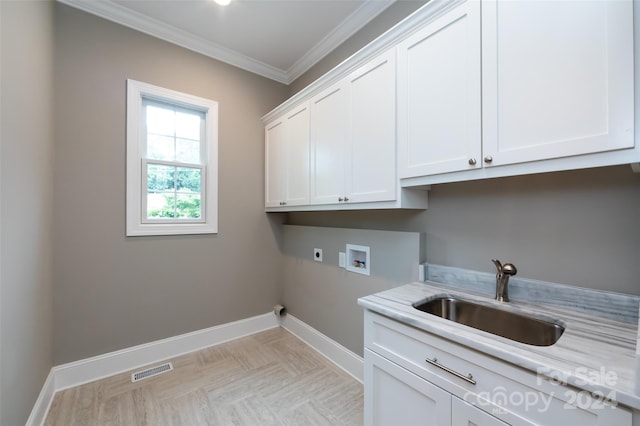 washroom with cabinets, sink, hookup for a washing machine, hookup for an electric dryer, and crown molding