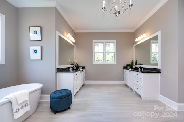 bathroom with an inviting chandelier, wood-type flooring, a tub, ornamental molding, and vanity