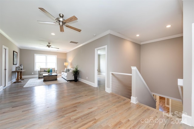 unfurnished living room with light hardwood / wood-style flooring and crown molding