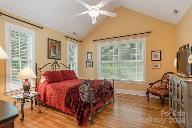 bedroom featuring light hardwood / wood-style floors, ceiling fan, and vaulted ceiling