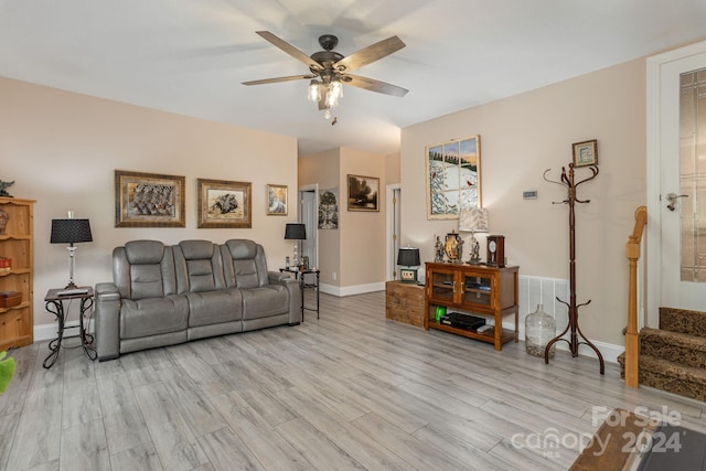 living room with light hardwood / wood-style floors and ceiling fan