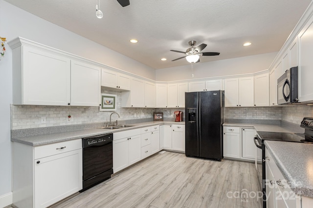 kitchen with light wood-type flooring, black appliances, white cabinets, backsplash, and ceiling fan